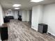 This finished basement has a gray wood floor, overhead lighting, a mini-fridge, and plenty of space at 4325 Dawning Ln, Douglasville, GA 30135
