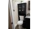 Well-organized bathroom with toilet, shower, and black storage cabinet for a functional layout at 4325 Dawning Ln, Douglasville, GA 30135