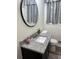 Bathroom with granite countertops, updated sink and fixtures, and a black framed mirror at 4325 Dawning Ln, Douglasville, GA 30135