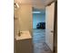 Well-lit bathroom leading to another room with a couch at 4325 Dawning Ln, Douglasville, GA 30135