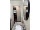 Bathroom featuring granite countertops, a framed mirror, and new wood flooring at 4325 Dawning Ln, Douglasville, GA 30135