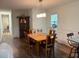 Traditional dining room adjacent to kitchen includes hardwood floors and modern chandelier at 4325 Dawning Ln, Douglasville, GA 30135