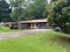 Charming single-story home with a manicured lawn, a two-car garage, and modern architectural elements at 4325 Dawning Ln, Douglasville, GA 30135