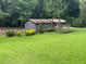 View of the exterior of a single story home featuring a large front lawn and mature trees at 4325 Dawning Ln, Douglasville, GA 30135
