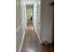 Hallway with hardwood flooring featuring white trim and doors to the rest of the home at 4325 Dawning Ln, Douglasville, GA 30135