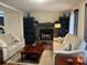 Cozy living room featuring stone fireplace, two sofas, wooden coffee table, and built in bookshelves at 4325 Dawning Ln, Douglasville, GA 30135