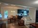 Open concept living room featuring laminate flooring, adjacent dining area, and easy access to the kitchen at 4325 Dawning Ln, Douglasville, GA 30135