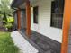 Side porch with dark gray tiling and rustic wood columns, providing an inviting outdoor space at 4325 Dawning Ln, Douglasville, GA 30135