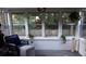 Bright sun room with large windows, cozy furniture and decorative hanging plants offers relaxing space at 4325 Dawning Ln, Douglasville, GA 30135