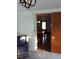 View of an adjacent dining room from a sun room with wooden sliding door and brick wall at 4325 Dawning Ln, Douglasville, GA 30135