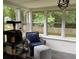 The sunroom offers a relaxing space with multiple windows overlooking the backyard at 4325 Dawning Ln, Douglasville, GA 30135