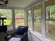 Bright sunroom features large windows with backyard views and comfortable wicker furniture at 4325 Dawning Ln, Douglasville, GA 30135