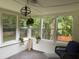 Sunroom shows the hardwood floors and large windows looking out into the yard at 4325 Dawning Ln, Douglasville, GA 30135