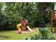 Wide backyard shot featuring a large wooden playset with slide, swing, and other playground equipment at 5070 Hensley Dr, Atlanta, GA 30338