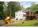Lush backyard with a playset, deck, and plenty of room for outdoor activities and relaxation at 5070 Hensley Dr, Atlanta, GA 30338
