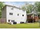 The backyard features a spacious lawn, a deck, and a charming, painted brick exterior at 5070 Hensley Dr, Atlanta, GA 30338