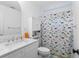 White bathroom featuring a dinosaur themed shower curtain and marble countertop at 5070 Hensley Dr, Atlanta, GA 30338