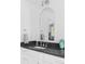 Bathroom features a white sink vanity, chrome faucet, and sleek rounded mirror at 5070 Hensley Dr, Atlanta, GA 30338