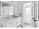 Well-lit bathroom with a marble countertop vanity, stainless steel fixtures, and white cabinets at 5070 Hensley Dr, Atlanta, GA 30338