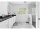 Bright bathroom features a double sink vanity, marble floors, and a glass shower at 5070 Hensley Dr, Atlanta, GA 30338