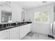 Bright bathroom features double vanity, black countertop, modern mirrors, and marble floors at 5070 Hensley Dr, Atlanta, GA 30338