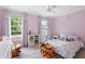 Pink bedroom features a white metal frame bed, bookshelf and two bright windows at 5070 Hensley Dr, Atlanta, GA 30338