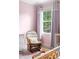 Bedroom showcasing a rocking chair, and a window with natural light at 5070 Hensley Dr, Atlanta, GA 30338