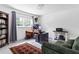 Bright bedroom featuring a large window, hardwood desk, and comfortable seating at 5070 Hensley Dr, Atlanta, GA 30338