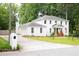 Charming white brick home with a well-manicured lawn and a long driveway at 5070 Hensley Dr, Atlanta, GA 30338