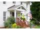 Charming entrance with a wood porch and an American flag at 5070 Hensley Dr, Atlanta, GA 30338