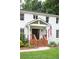 Charming entrance with a wood porch and an American flag at 5070 Hensley Dr, Atlanta, GA 30338