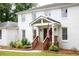 Close-up of the front porch featuring wooden stairs, landscaping, and visible house numbers at 5070 Hensley Dr, Atlanta, GA 30338