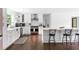 Stylish kitchen features white cabinets, stainless appliances, a center island with seating, and hardwood floors at 5070 Hensley Dr, Atlanta, GA 30338