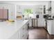 Spacious kitchen with a large white countertop island, stainless steel appliances, and hardwood floors at 5070 Hensley Dr, Atlanta, GA 30338