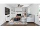 Bright living room with hardwood floors, white brick fireplace, built-in shelves, and comfortable seating at 5070 Hensley Dr, Atlanta, GA 30338