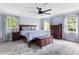 Serene main bedroom with light blue walls, hardwood furniture, and two bright windows at 5070 Hensley Dr, Atlanta, GA 30338
