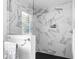 Modern shower featuring sleek marble tiles and a built-in toiletry niche at 5070 Hensley Dr, Atlanta, GA 30338