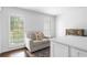Cozy sitting area with a comfortable couch, shiplap wall, and view to the backyard at 5070 Hensley Dr, Atlanta, GA 30338