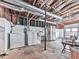 Basement featuring unfinished walls and ceiling, with a washer, dryer, utility sink, and a refrigerator at 629 Silver Trace Ct, Woodstock, GA 30189