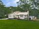 Well-maintained home with a metal roof, brick chimney, and tidy landscaping at 629 Silver Trace Ct, Woodstock, GA 30189