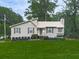 Charming home featuring green lawn, landscaped garden beds and lovely neutral siding and brick accents at 629 Silver Trace Ct, Woodstock, GA 30189