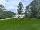 Charming home with mature trees, lush green grass, and established landscape from street at 629 Silver Trace Ct, Woodstock, GA 30189