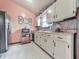 Bright kitchen featuring vintage cabinetry, modern appliances, and durable flooring at 629 Silver Trace Ct, Woodstock, GA 30189