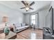 Relaxing living room featuring a large window for natural light, hardwood floors, and a comfortable sofa at 629 Silver Trace Ct, Woodstock, GA 30189
