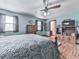 A closer view of the main bedroom featuring a walk-in closet, ceiling fan, wood floors, and a king size bed at 629 Silver Trace Ct, Woodstock, GA 30189
