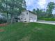 Rear exterior view showing a two-story home and 2-car garage at 629 Silver Trace Ct, Woodstock, GA 30189