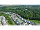 Aerial view pointing to a home in a neighborhood near a wooded area at 1820 Primrose Park Rd, Sugar Hill, GA 30518