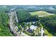 Beautiful aerial view of the community featuring a pool, tennis courts, and lush green landscaping at 1820 Primrose Park Rd, Sugar Hill, GA 30518