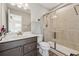 Bathroom featuring a glass shower, wood-look flooring, and modern sink vanity at 1820 Primrose Park Rd, Sugar Hill, GA 30518