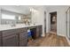 Bathroom boasts double vanities, a large mirror, modern fixtures, and a walk-in closet for ample storage at 1820 Primrose Park Rd, Sugar Hill, GA 30518